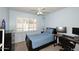 Bright bedroom with blue walls and accents featuring a large window with white shutters at 2424 E Aster Dr, Phoenix, AZ 85032