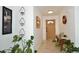 Inviting foyer adorned with plants and art, leading to a warm wooden front door at 2424 E Aster Dr, Phoenix, AZ 85032