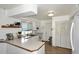 Functional kitchen with wooden floors, white cabinets, modern appliances, and ample countertop space at 2424 E Aster Dr, Phoenix, AZ 85032
