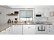 Bright kitchen featuring white cabinets, ample counter space, and modern appliances at 2424 E Aster Dr, Phoenix, AZ 85032