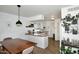 Kitchen that features modern light fixtures, white cabinets, view into the dining area and lots of plants at 2424 E Aster Dr, Phoenix, AZ 85032