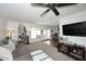 Inviting living room with a large comfortable sofa, ceiling fan, and view to dining area through sliding glass doors at 2424 E Aster Dr, Phoenix, AZ 85032