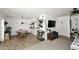 Living space that features wood floors, view into the kitchen, large sectional sofa, and lots of plants at 2424 E Aster Dr, Phoenix, AZ 85032