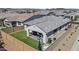 Aerial view of the backyard with patio, fireplace, and lush green lawn in a residential neighborhood at 24540 N 144Th Ave, Surprise, AZ 85387