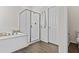 Modern bathroom featuring a soaking tub, walk-in shower, and a separate toilet area at 24540 N 144Th Ave, Surprise, AZ 85387