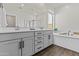 Primary bathroom with double vanity, a garden tub, and modern finishes at 24540 N 144Th Ave, Surprise, AZ 85387