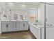 Contemporary bathroom featuring a double vanity, soaking tub, and a walk-in shower at 24540 N 144Th Ave, Surprise, AZ 85387