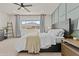 Cozy bedroom featuring a plush carpet, ceiling fan, and large window with natural lighting at 24540 N 144Th Ave, Surprise, AZ 85387