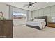 Bright bedroom with a ceiling fan, and large window overlooking the community at 24540 N 144Th Ave, Surprise, AZ 85387