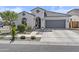 Charming stucco home featuring a tile roof, arched entry, and a well-manicured front yard at 24540 N 144Th Ave, Surprise, AZ 85387