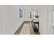 Inviting hallway with shiplap accent wall, console table, and stylish rug leading to the front door at 24540 N 144Th Ave, Surprise, AZ 85387