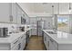 Modern kitchen with light gray cabinets, stainless steel appliances, and white countertops at 24540 N 144Th Ave, Surprise, AZ 85387