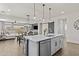 Beautiful open concept kitchen featuring a large island with stainless steel appliances and modern lighting fixtures at 24540 N 144Th Ave, Surprise, AZ 85387