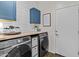 Well-organized laundry room with modern washer and dryer and ample storage space at 24540 N 144Th Ave, Surprise, AZ 85387
