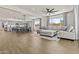 Open-concept living room and kitchen combination with tile floors and neutral colored decor at 24540 N 144Th Ave, Surprise, AZ 85387