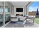 Outdoor patio with comfortable seating, modern fireplace, and mounted TV for relaxation at 24540 N 144Th Ave, Surprise, AZ 85387