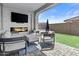 Outdoor patio with fireplace, seating, and a green space for entertaining friends and Gathering at 24540 N 144Th Ave, Surprise, AZ 85387