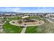 Neighborhood playground featuring swings, slides, and climbing structures surrounded by lush green grass and a walking path at 24540 N 144Th Ave, Surprise, AZ 85387