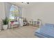 Spacious playroom with large window, kitchen, and organized storage shelves at 24540 N 144Th Ave, Surprise, AZ 85387