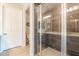 Modern bathroom features a glass-enclosed shower with gray tiles, and a double vanity at 250 W Queen Creek Rd # 206, Chandler, AZ 85248