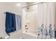Bathroom with white tub and shower with patterned curtain, two towels, and stainless steel fixtures at 250 W Queen Creek Rd # 206, Chandler, AZ 85248