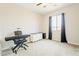Bedroom with neutral carpet, ceiling fan, window with curtains, and writing table with piano and stool at 250 W Queen Creek Rd # 206, Chandler, AZ 85248