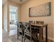 Cozy dining area with a wooden table, four chairs, and an adjacent view of the Primary bedroom at 250 W Queen Creek Rd # 206, Chandler, AZ 85248