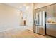 Modern kitchen showcases stainless steel refrigerator and access to the dining area at 250 W Queen Creek Rd # 206, Chandler, AZ 85248
