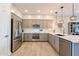 Modern kitchen features sleek gray cabinets, stainless steel appliances, and quartz countertops at 250 W Queen Creek Rd # 206, Chandler, AZ 85248