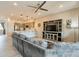 Open living space with a large gray sofa, adjacent kitchen, and a modern ceiling fan at 250 W Queen Creek Rd # 206, Chandler, AZ 85248