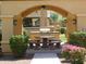 Outdoor grill and seating area with ceiling fan and mature landscaping at 250 W Queen Creek Rd # 206, Chandler, AZ 85248