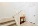 Carpeted staircase featuring a white banister and natural light, leading to the upper level at 250 W Queen Creek Rd # 206, Chandler, AZ 85248