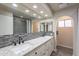 A bathroom with double vanity, granite countertops, mosaic backsplash, and recessed lighting at 2502 E Malibu Dr, Tempe, AZ 85282