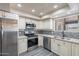 Modern kitchen featuring stainless steel appliances, light cabinets, and stone countertops at 2502 E Malibu Dr, Tempe, AZ 85282