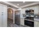 Kitchen with stainless steel appliances, white cabinetry and gray tiled backsplash at 2502 E Malibu Dr, Tempe, AZ 85282