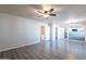 Living room with ceiling fan, grey toned floors and white painted walls at 2502 E Malibu Dr, Tempe, AZ 85282