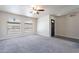 Spacious living room with arched windows, ceiling fan, and neutral-toned carpet at 2502 E Malibu Dr, Tempe, AZ 85282