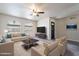 Bright living room featuring two couches, coffee table, ceiling fan, and arched windows at 2502 E Malibu Dr, Tempe, AZ 85282