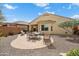 Large backyard featuring desert landscaping, brick-paver patio, and seating area, perfect for outdoor gatherings at 27030 W Escuda Dr, Buckeye, AZ 85396