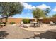 Spacious backyard with a brick-paver patio area and seating, plus desert landscaping at 27030 W Escuda Dr, Buckeye, AZ 85396
