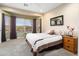 Bright bedroom with a large window, neutral décor, and a comfortable bed with brown accents at 27030 W Escuda Dr, Buckeye, AZ 85396