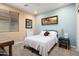 Bedroom featuring a well-lit interior, carpeted floors, and a full-sized bed at 27030 W Escuda Dr, Buckeye, AZ 85396