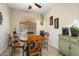 Charming dining area with a round wooden table and views of the backyard at 27030 W Escuda Dr, Buckeye, AZ 85396