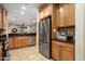 Open-concept kitchen with stainless steel refrigerator and views into the living area at 27030 W Escuda Dr, Buckeye, AZ 85396