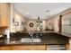 Open kitchen with a stainless steel sink overlooking the living room and backyard at 27030 W Escuda Dr, Buckeye, AZ 85396