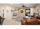 Comfortable living room with a ceiling fan, tile flooring, a leather sofa, and access to the backyard at 27030 W Escuda Dr, Buckeye, AZ 85396