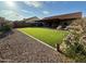 A backyard with gravel, turf and a covered porch at 2705 E Rock Wren Rd, Phoenix, AZ 85048