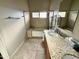 Bathroom featuring a double vanity with granite counters and a tub with tiled surround at 2705 E Rock Wren Rd, Phoenix, AZ 85048