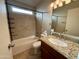 Bathroom featuring a tiled shower/tub combo, granite counters and vanity lighting at 2705 E Rock Wren Rd, Phoenix, AZ 85048