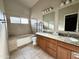 Bathroom with double sinks, granite countertops, and a tub/shower combination at 2705 E Rock Wren Rd, Phoenix, AZ 85048